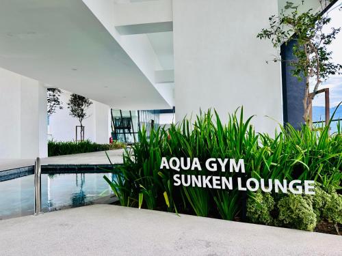 a swimming pool in a building with a sign that reads ayoya gym summer lounge at New Comfy Urban Suite Homestay at Georgetown for family by Urban Staycations LOD in Jelutong