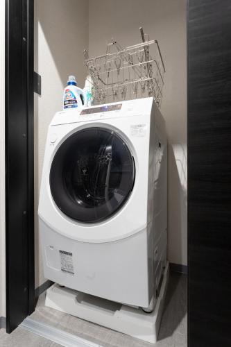 a washing machine with a basket on top of it at SMART VILLA Hakone Sukumogawa Riverside in Hakone