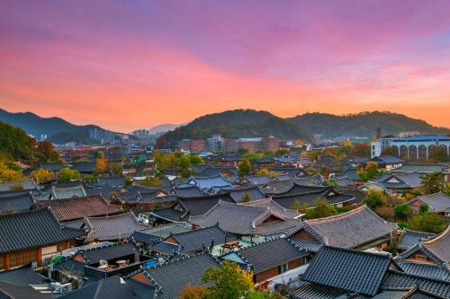 an overhead view of a city with roofs and mountains at Lahan Hotel Jeonju in Jeonju