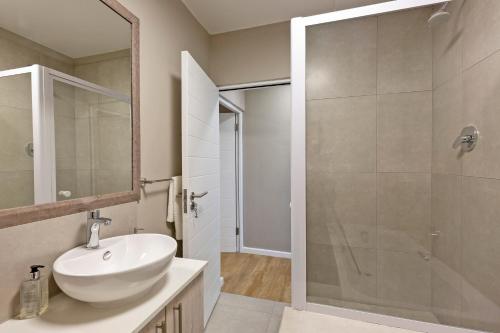 a bathroom with a sink and a shower at Nivica 46 Luxury Apartment Langebaan in Langebaan
