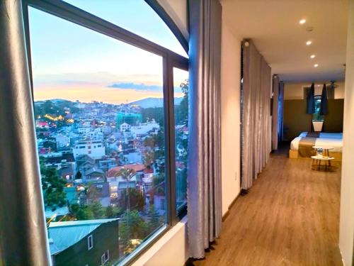 a hotel room with a view of a city at Torino Hotel Dalat in Da Lat