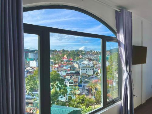 a window with a view of a city at Torino Hotel Dalat in Da Lat