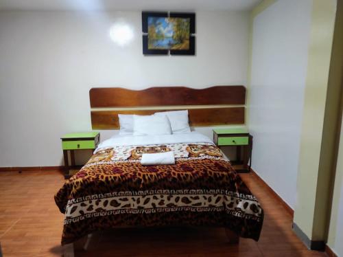 a bedroom with a large bed with two night stands at Sierra Verde - Muy Céntrico Hs in Huancayo