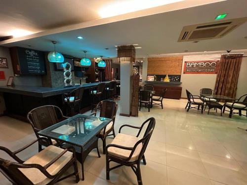 a restaurant with tables and chairs and a bar at LUCKY WAYS PATONG HOTEL in Patong Beach