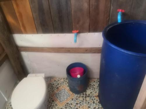 a small bathroom with a toilet and a trash can at Friend of Nature Bungalow in Koh Rong Island