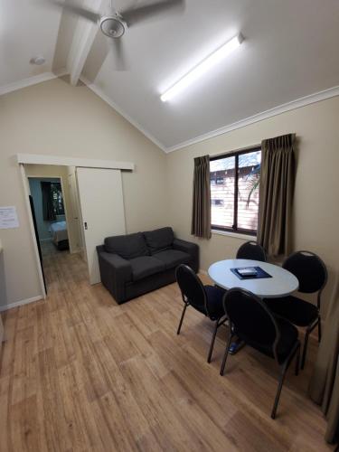 a living room with a table and chairs and a couch at 1770 Holiday Village in Seventeen Seventy