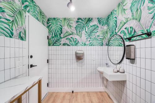 a bathroom with a sink and a mirror at Lux Retreat By Renzzi in Miami