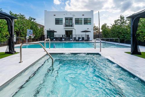 a swimming pool in front of a house at Lux Retreat By Renzzi in Miami