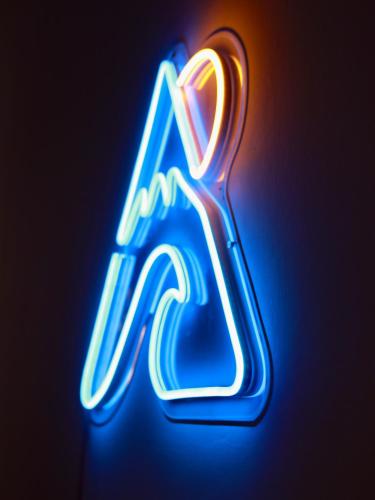 a neon sign with the letter a in blue and red at Cube 8teens by Nest Home in Johor Bahru