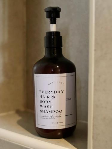 a bottle of shampoo sitting on a shelf at Cube 8teens by Nest Home in Johor Bahru