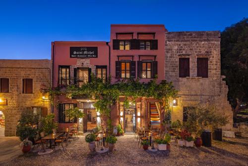 een oud gebouw met planten ervoor bij Saint Michel Boutique Hotel in Rhodos-stad