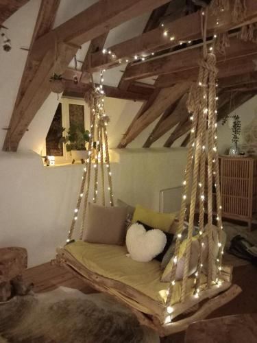 a swinging bed with lights in a room at Nid d amoureux in La Roque-Gageac