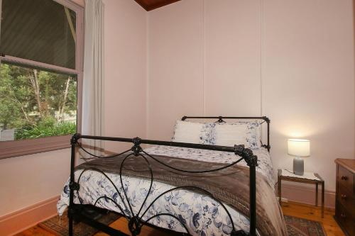 a bed in a room with a window at Allen Street in Beechworth