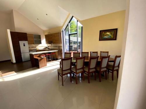 a kitchen and dining room with a table and chairs at Villadzor Apart Hotel in Tsaghkadzor