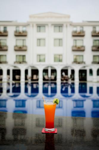 a drink sitting on a table with a lime on it at Ramada by Wyndham Goa Vagator in Vagator