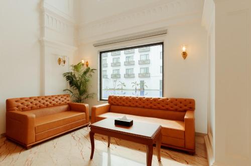 a living room with two couches and a table at Ramada by Wyndham Goa Vagator in Vagator