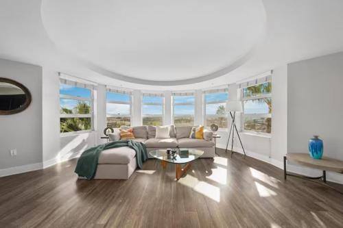 a living room with a couch and a table at Blue Topaz Retreat - Spacious 3BR Gorgeous City views in Los Angeles