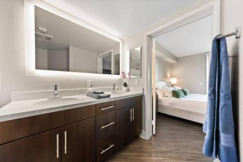 a bathroom with a sink and a large mirror at Beautiful & Spacious Santa Monica Retreat 3BD 2BA in Los Angeles