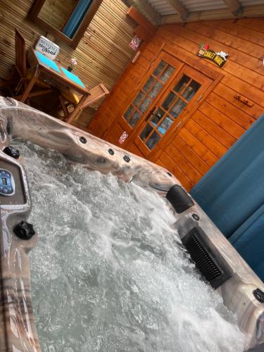 an indoor water slide in a room with a table at Les Chalets de marie 2 - Vue mer, Jacuzzi SPA privatif dans le chalets Sans vis à vis in Saint-Denis