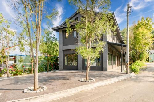 a house with two trees in front of it at 普莫里行旅 包棟民宿 in Puli