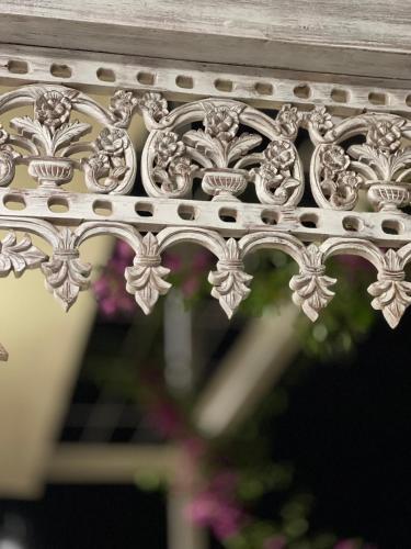 a close up of a white railing with flowers at Mambo Hill Resort in Nusa Penida