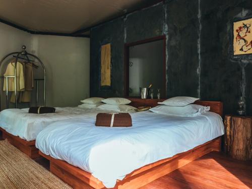 a large white bed with a large mirror on it at La Terra Resort in Shiojiri