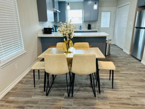 a kitchen with a table and chairs in a kitchen at Modern apt-King bed-Free parking-Wi-fi in Brownsville