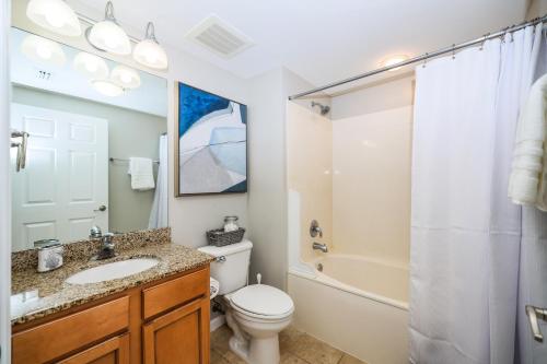 a bathroom with a toilet and a sink and a shower at Marvelous Palms of Destin Condo with Pool View in Destin