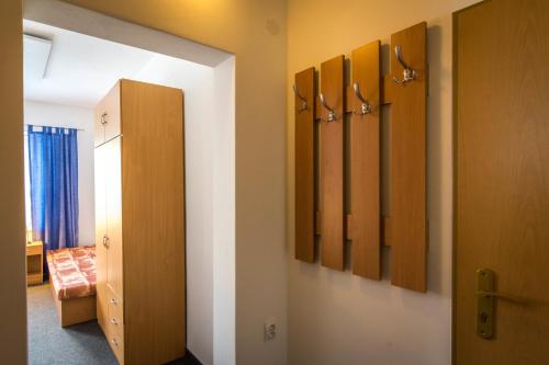 a hallway with a room with a door and a room with a bed at Ubytovňa Pali in Kežmarok