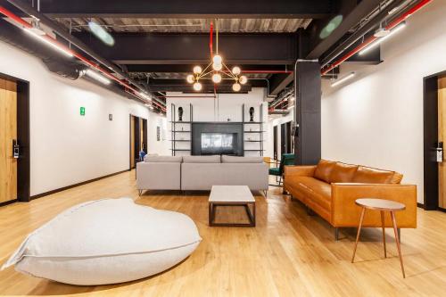 a living room with a couch and a table at Mariano Escobedo 48 in Mexico City