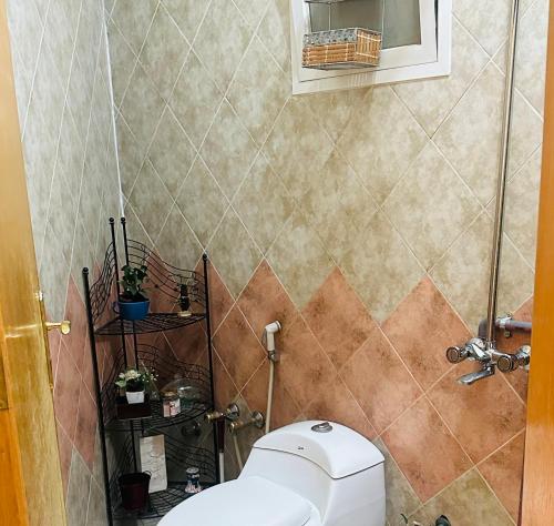 a bathroom with a white toilet in a room at دور بغرفتين نوم في المحمدية شمال الرياض in Riyadh