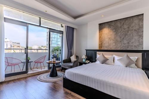 a bedroom with a large bed and a balcony at Park View Luxury Hotel in Ho Chi Minh City