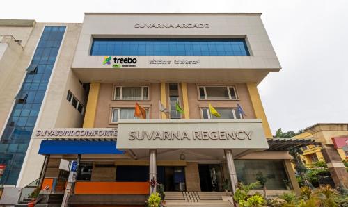 a building with a sign that reads swaran residency at Treebo Trend Suvarna Comforts in Hassan