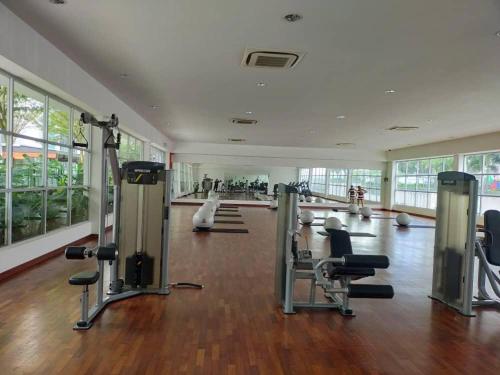 a gym with treadmills and chairs in a room at Meridin Bayvue Sea View Homestay by JP in Masai