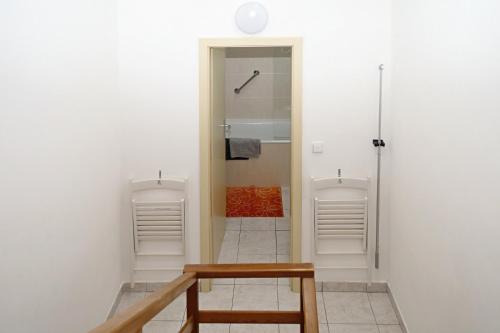 a bathroom with a shower and a sink and a bench at Apartmán Hopi Hopi Svoboda nad Úpou in Svoboda nad Úpou
