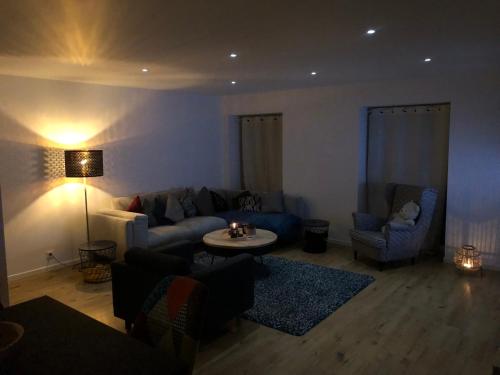 a living room with a couch and chairs and a table at Spa-Francorchamps / Jahlay Maison 6p de caractère in Jalhay