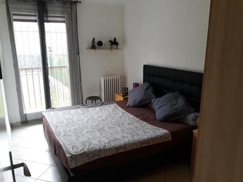 a bedroom with a bed and a large window at Chambre A2 dans un appartement en colocation in Marseille