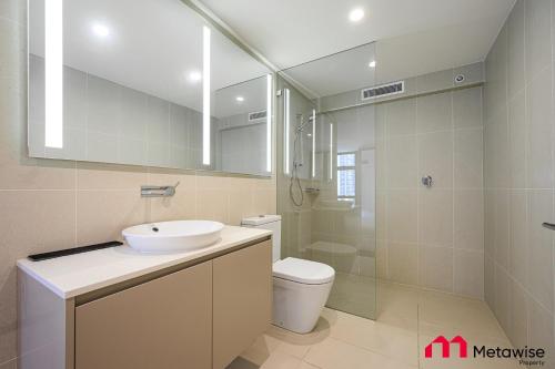 a bathroom with a sink and a toilet and a shower at MetaWise Sydney CBD Haymarket Luxe 2Bed Penthouse Bella in Sydney