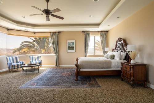 a bedroom with a bed with a ceiling fan at Sangiovese By AvantStay Spectacular Estate w Pool Hot Tub Putting Green in Temecula