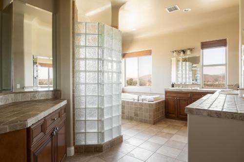 a large bathroom with a tub and a sink at Sangiovese By AvantStay Spectacular Estate w Pool Hot Tub Putting Green in Temecula