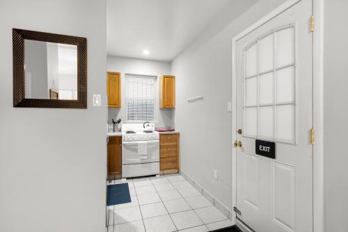 a kitchen with a white door and a sink at Cozy Studio Apt Near Rittenhouse Square in Philadelphia