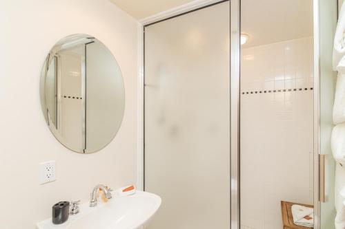 a bathroom with a shower and a sink and a mirror at Westermere 311 - 2 by AvantStay Just Steps From Ski Area w Great Views in Telluride