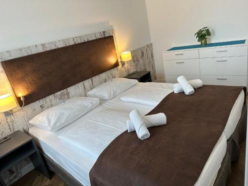 a bedroom with two beds with white pillows at Versava Apartments in Vienna