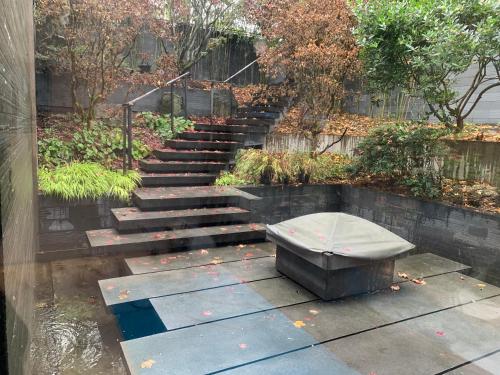 a bench sitting in front of a set of stairs at S-Villa plus Water Feature & Zen Garden in Vancouver