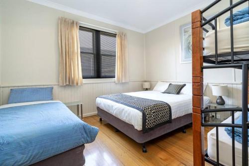 a bedroom with two beds and a bunk bed at Bradman House CBD Launceston Invermay + Free WIFI in Launceston