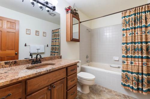 a bathroom with a sink and a toilet and a tub at Riverside Condos B101 by AvantStay Condo Close To Downtown Town Park Ski Lift 8 in Telluride