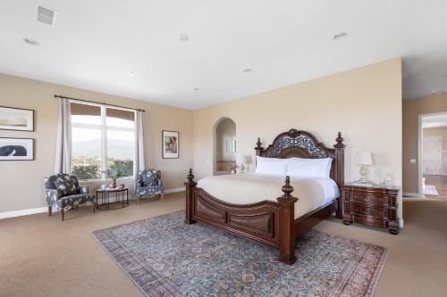 1 dormitorio con cama grande y ventana grande en Palazzo Del Sol By AvantStay Breathtaking Home w Mountain Views Hot Tub, en Temecula