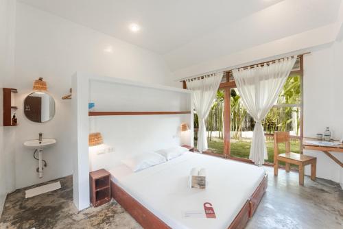a bedroom with a large white bed and a window at Blauset Two in General Luna