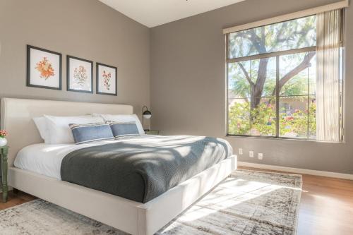 a bedroom with a bed and a large window at Dwight by AvantStay Blissful Serene Oasis Pool Firepit Entertainers Patio in Phoenix