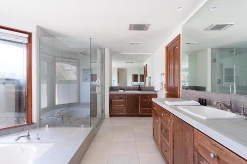 a large bathroom with two sinks and a shower at Cathedral by AvantStay Charming Secluded Estate w Sauna Pool Table Views of the Rolling Hills in Paso Robles